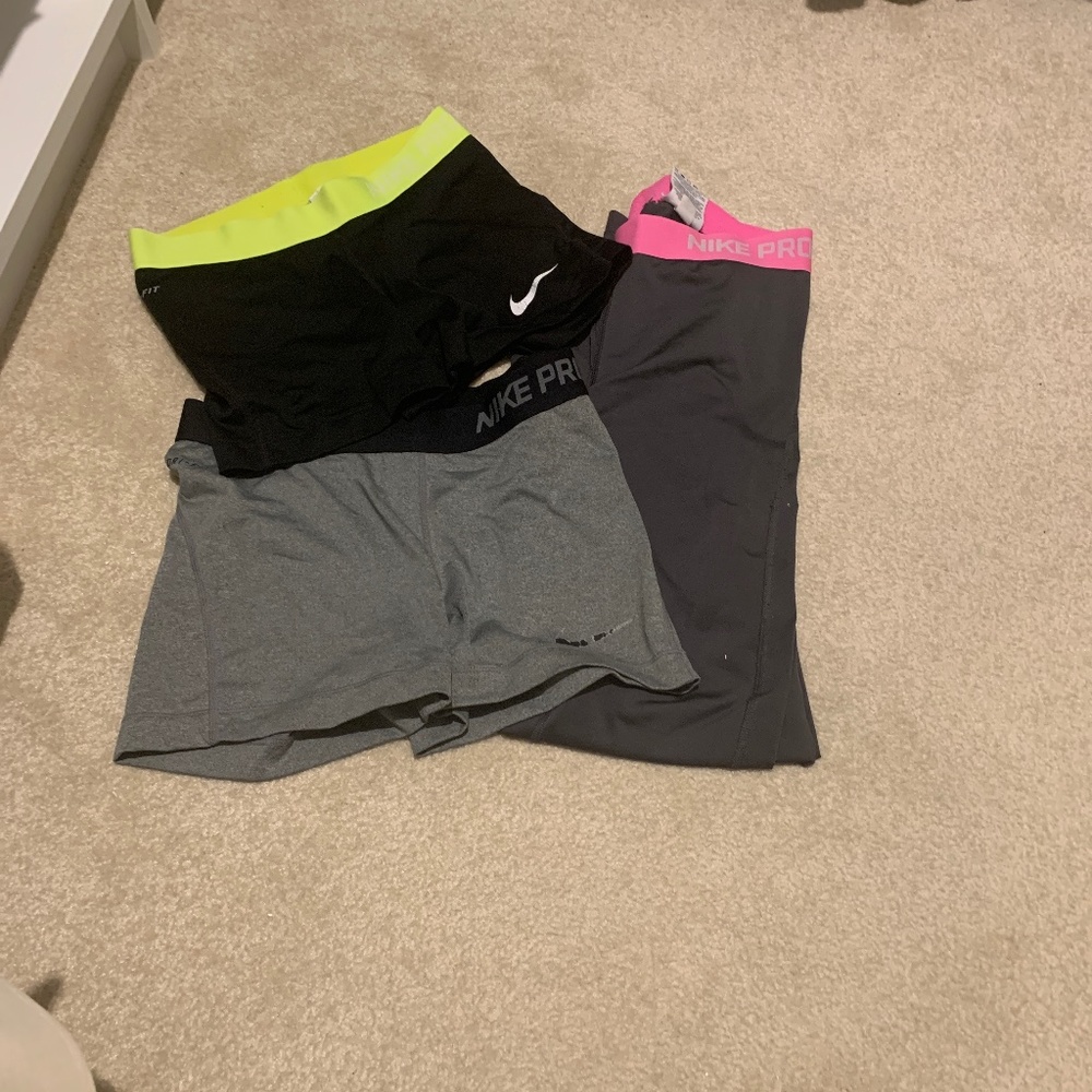 Two Nike pro shorts and one pair of  pants